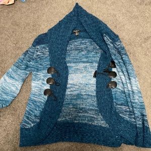 Blue cardigan. Is missing a button thing.